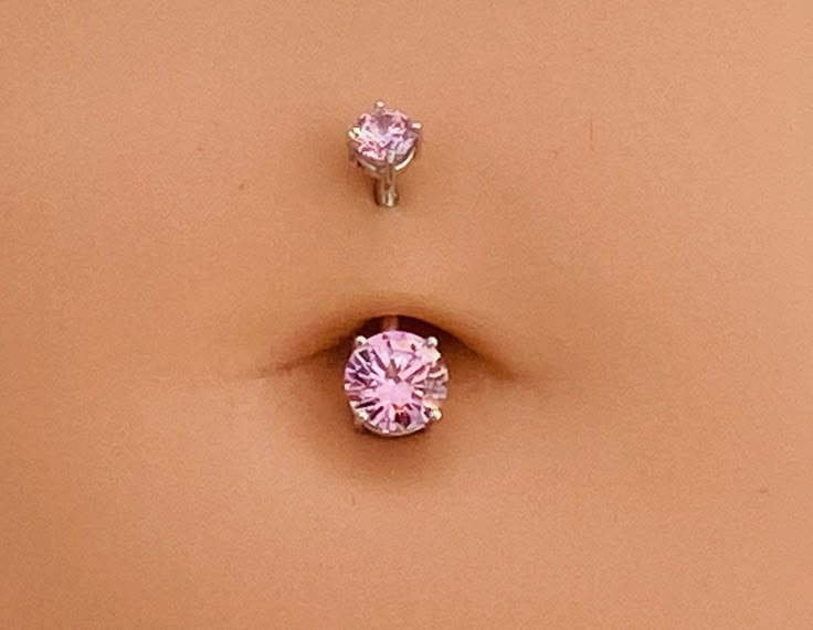 two pink diamond studs sitting next to each other