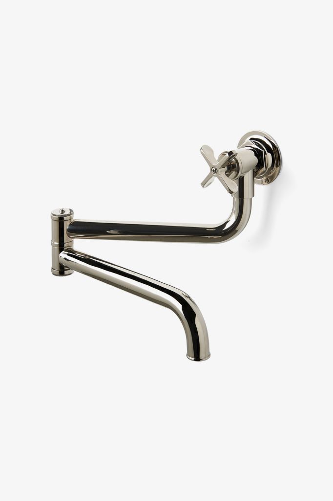 a metal wall mounted faucet with two handles