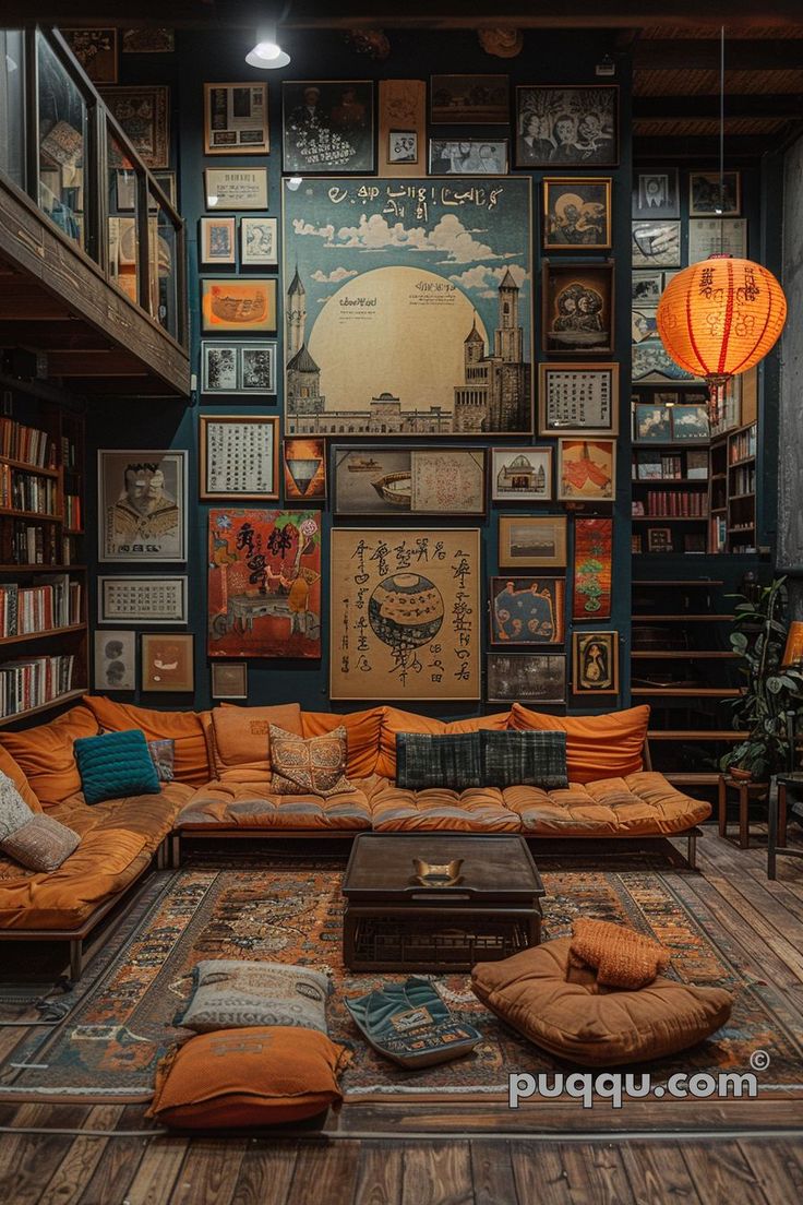 a living room filled with lots of furniture and books on the wall above it is an orange couch surrounded by pillows