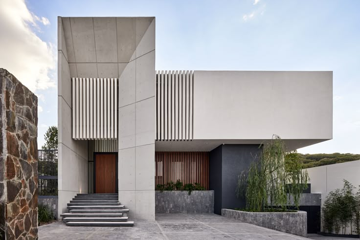 an exterior view of a modern house with stone steps