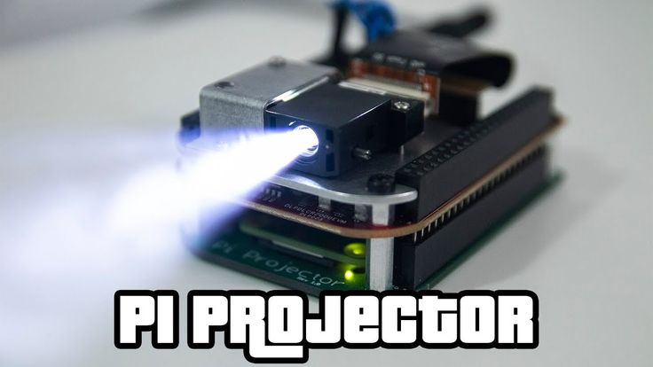 a projector is being used to light up the camera's lens as it sits on top of an electronic board