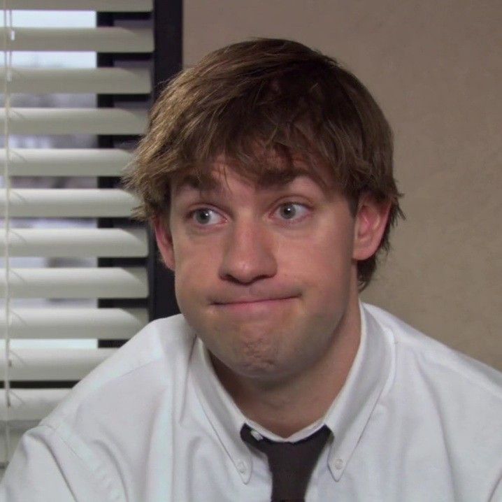 a man in a tie is looking at the camera