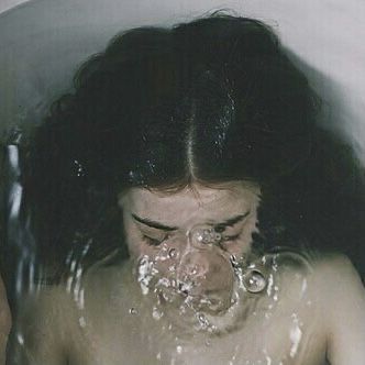 a woman with her face covered in water