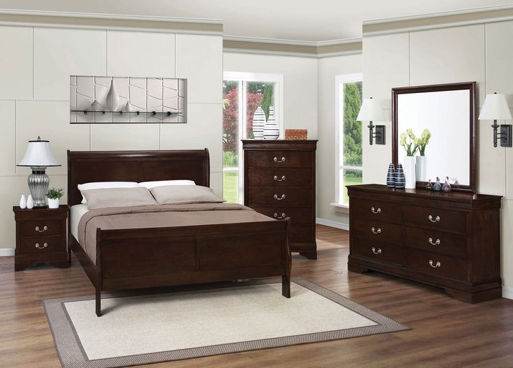 a bedroom scene with focus on the bed, dresser and mirror in the room's center