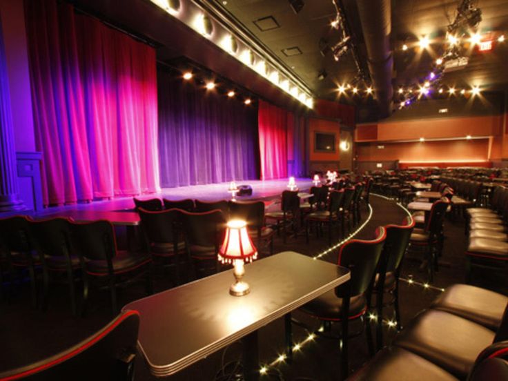 an empty theater is lit up with purple and red lights