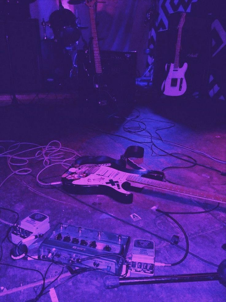 an electric guitar and other musical equipment on the floor