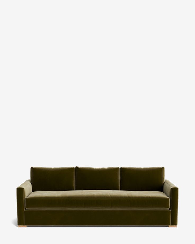 a green couch against a white wall