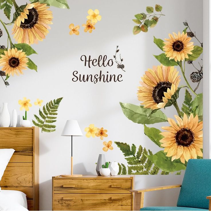 a bedroom with sunflowers painted on the wall and a blue chair in front