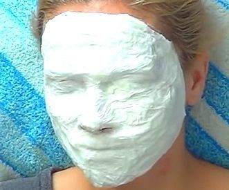 a woman with a facial mask on her face