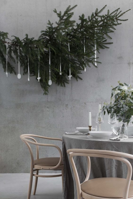 the table is set with two chairs and one chair has a plant hanging from it