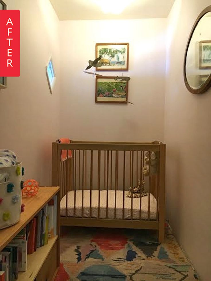 a baby's room with a crib and bookshelf in the corner