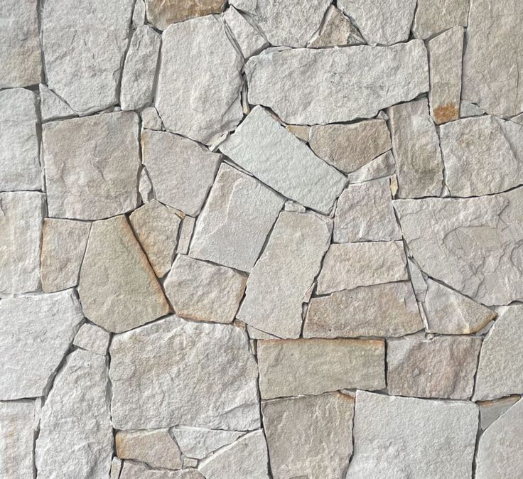 a stone wall that looks like it has been made out of various types of stones