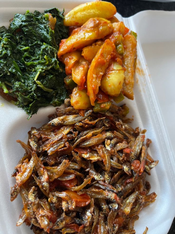 a white plate topped with different types of food on top of a plastic container filled with vegetables