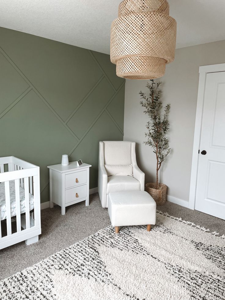 a baby's room with a crib, chair and dresser