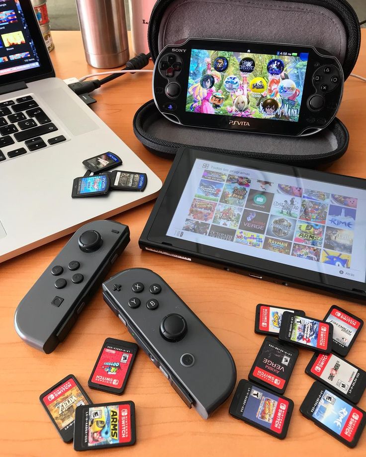 several nintendo wii game controllers sitting next to an open laptop