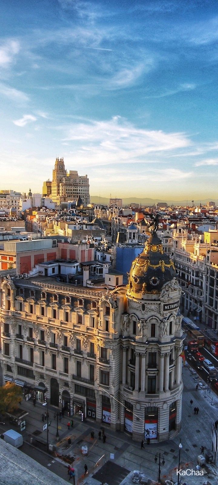 an aerial view of a large building in the middle of a city with tall buildings