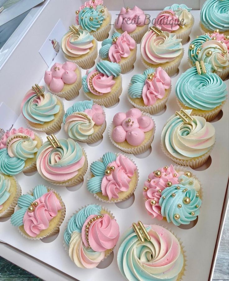 there are many cupcakes that have been decorated with pastel and gold icing