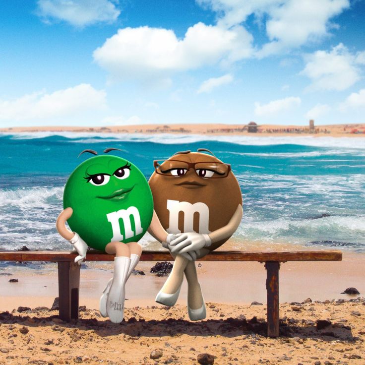 two cartoon characters sitting on a bench next to the ocean, one holding an m & m ball