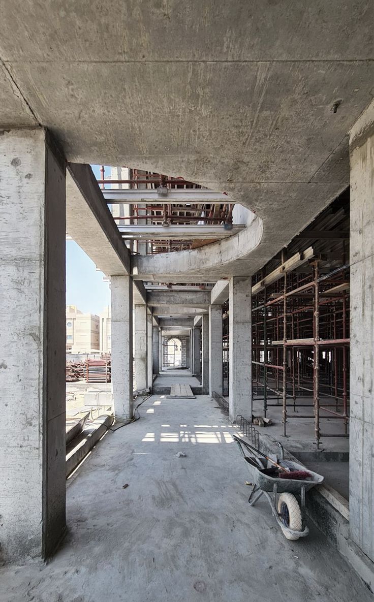 an empty concrete building with scaffolding on the sides