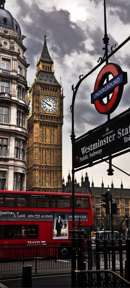 a red double decker bus driving past big ben and the clock tower in london, england