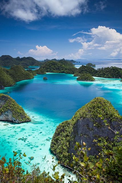 an aerial view of the blue lagoons and islands