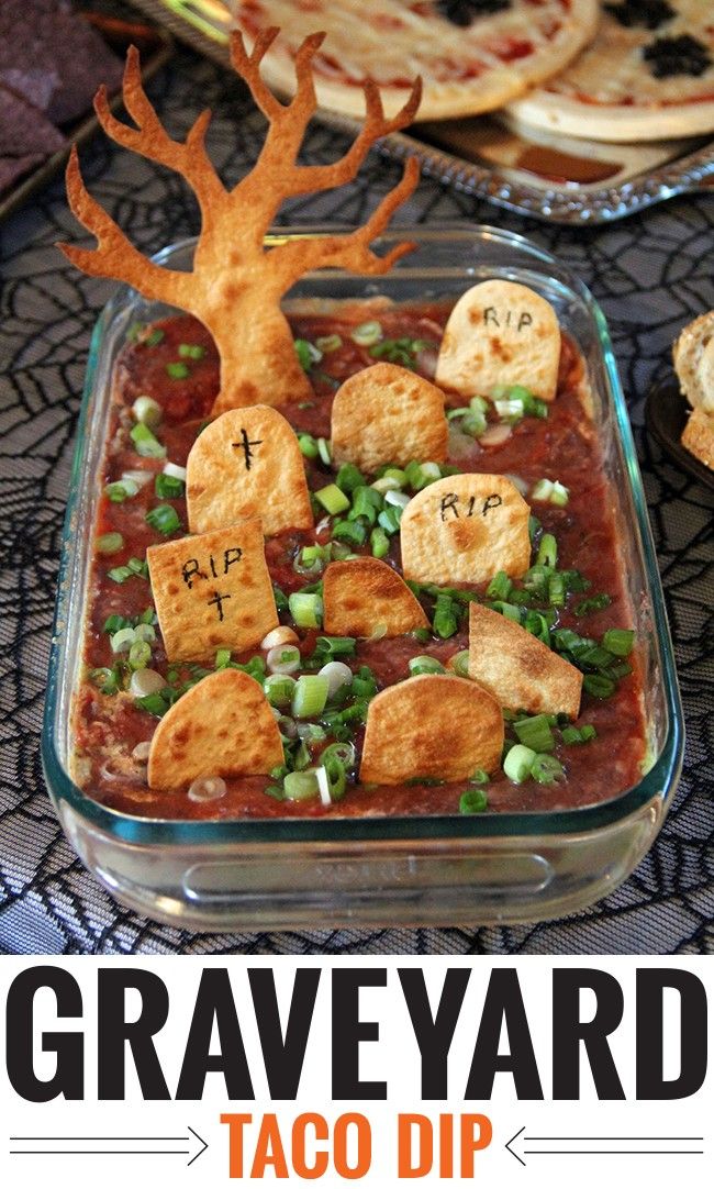 a close up of food in a pan on a table with text overlay that reads graveyard taco dip