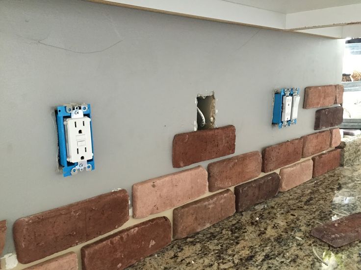 a kitchen counter with some electrical outlets on the wall