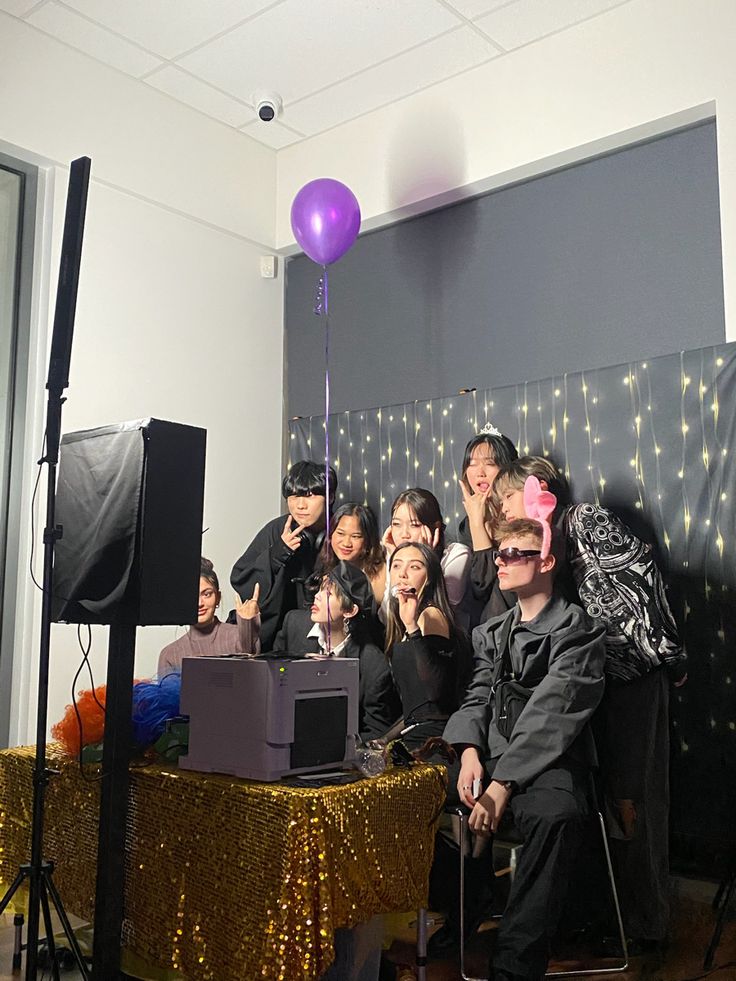 a group of people sitting in front of a cake