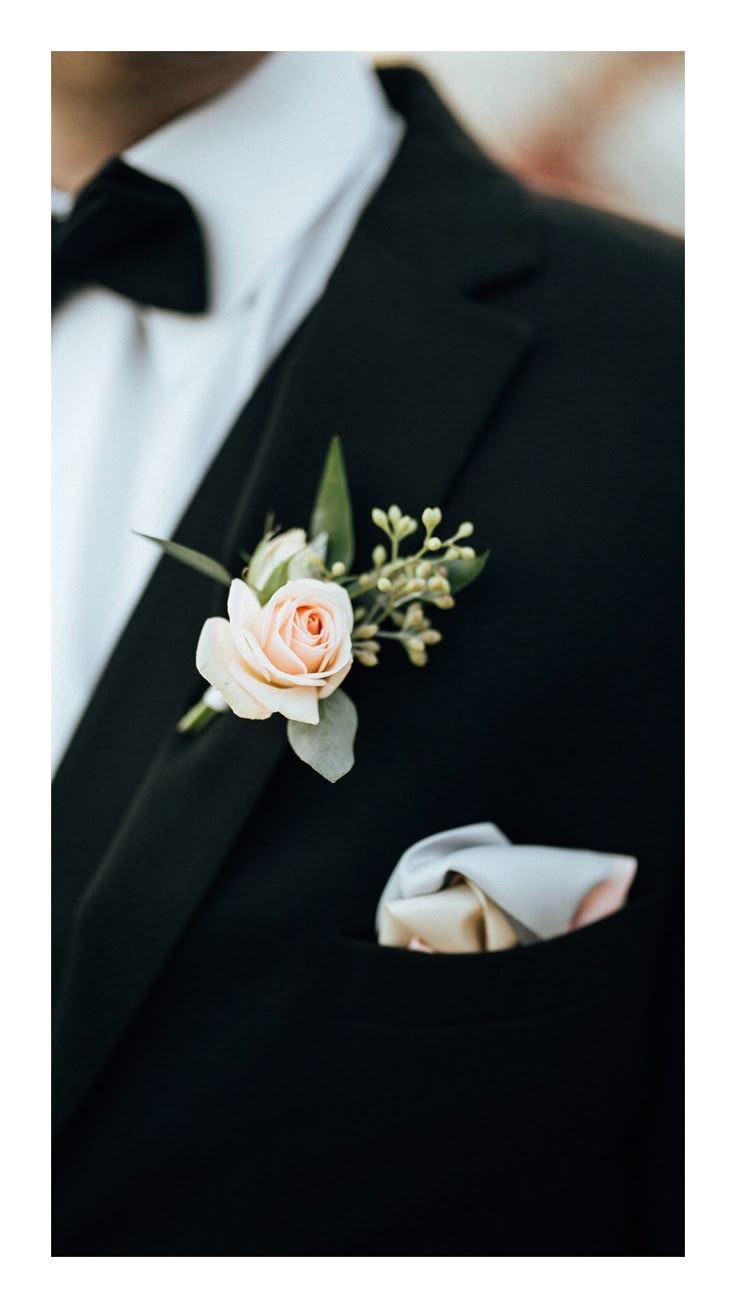 a man in a tuxedo wearing a boutonniere