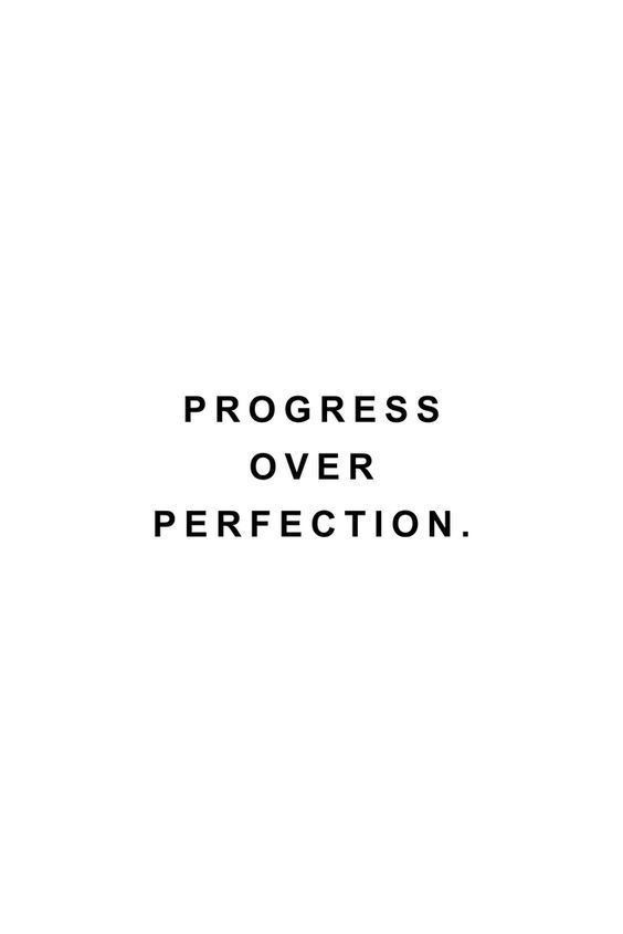 the words progress over perfection are black and white