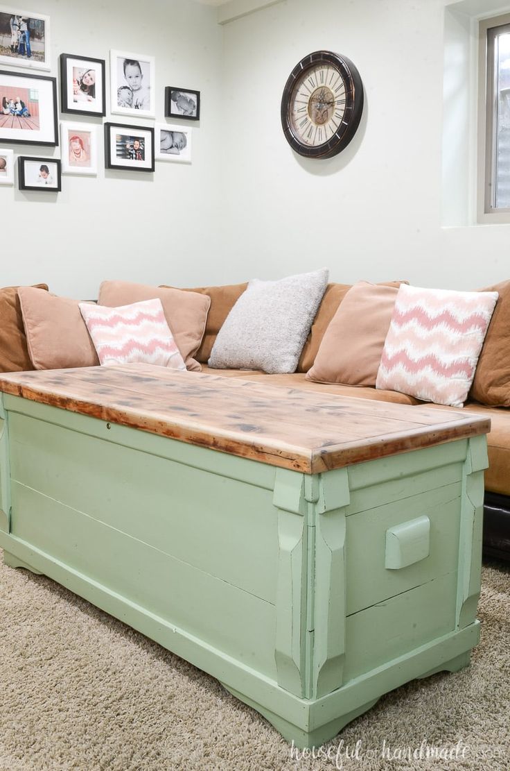 a living room with a couch, coffee table and pictures on the wall above it