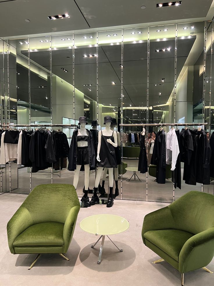 a green chair sitting in front of a mirror next to a mannequin's head