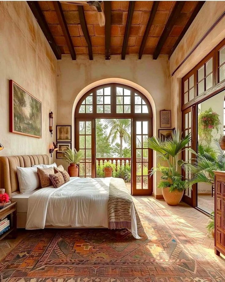 a large bedroom with an arched window and wooden furniture