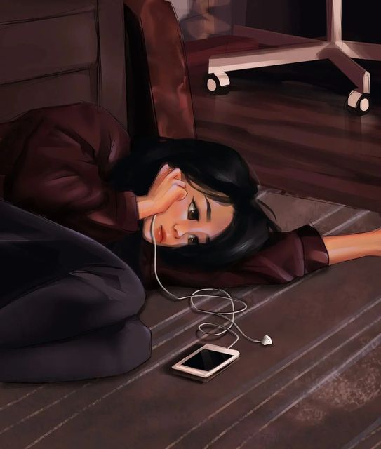 a woman laying on the floor listening to music