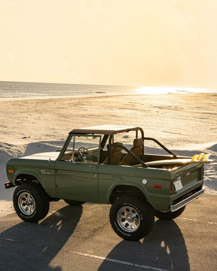 an old pick up truck parked on the beach