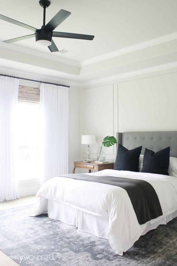 a bedroom with white walls and black accents