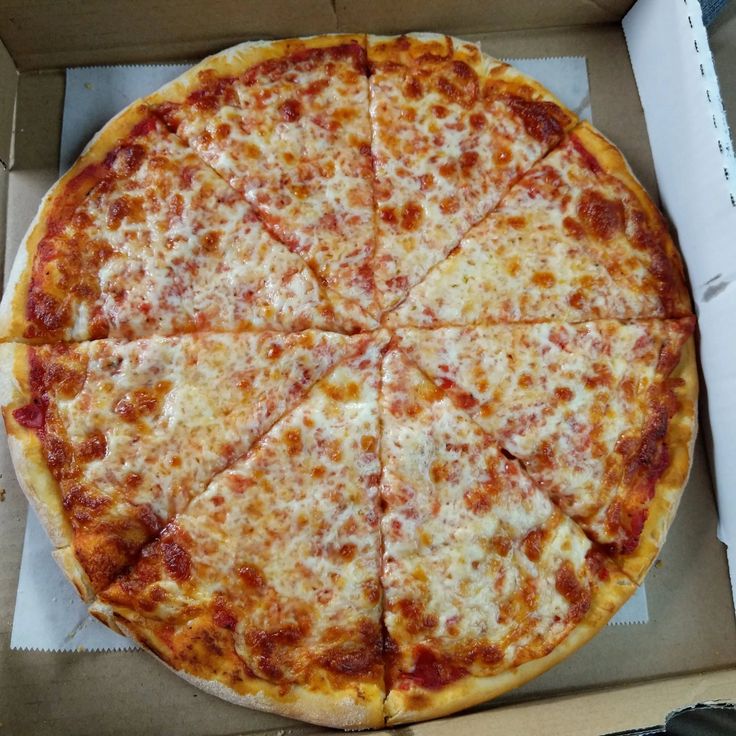 a large pizza sitting in a box on top of a table