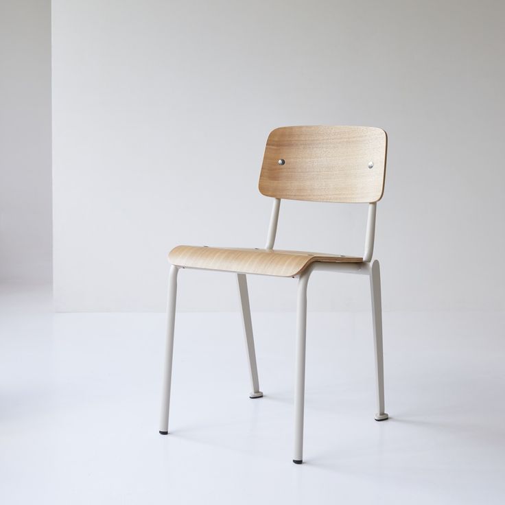 a wooden chair sitting on top of a white floor