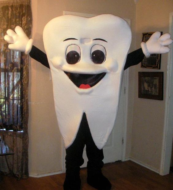 a tooth mascot standing in the middle of a room