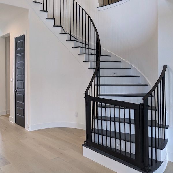 a white and black spiral staircase in a house