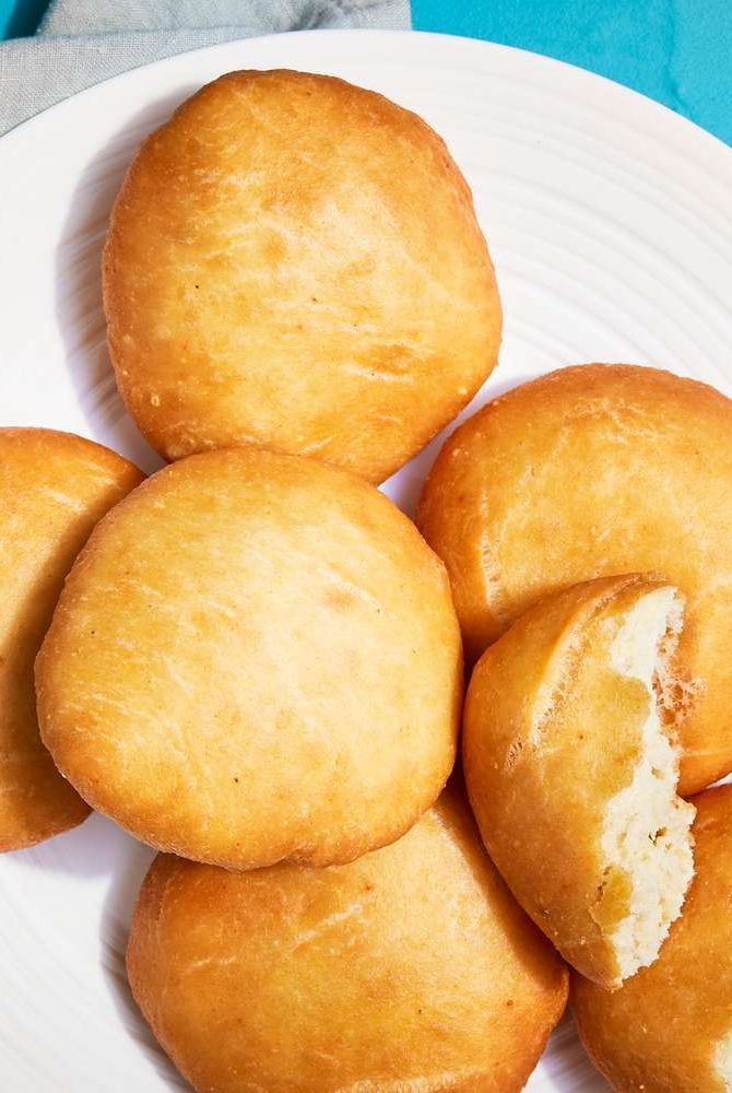 a white plate topped with donuts on top of a blue and white table cloth