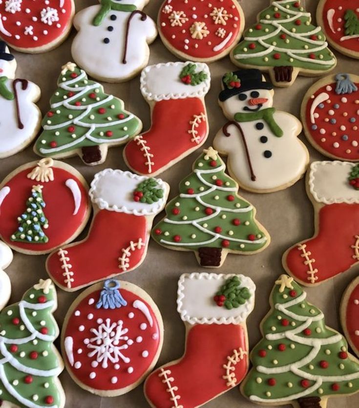 decorated christmas cookies are displayed on a table