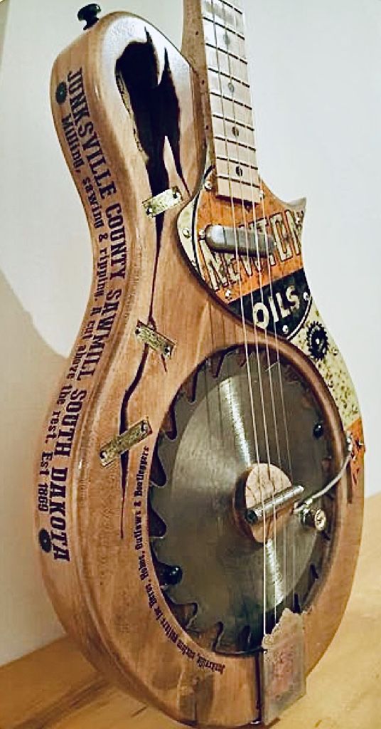 a clock made out of an old guitar