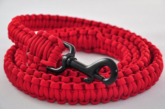 a close up of a red rope with a black hook