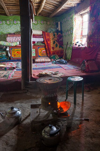 a room filled with lots of different types of furniture and decor on the floor next to an open fire place