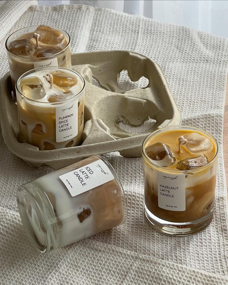 three jars filled with liquid sitting on top of a table next to an empty tray