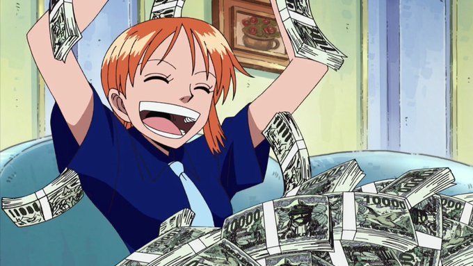 a person laying on top of a bed full of money with their hands in the air