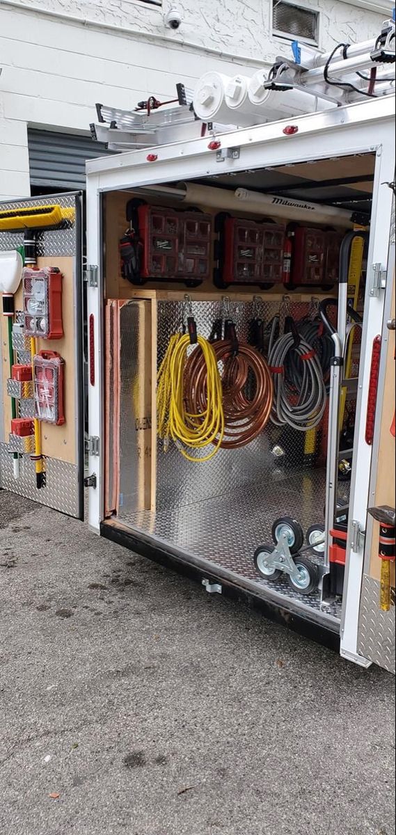 the inside of a fire truck with hoses and other items in its storage compartment