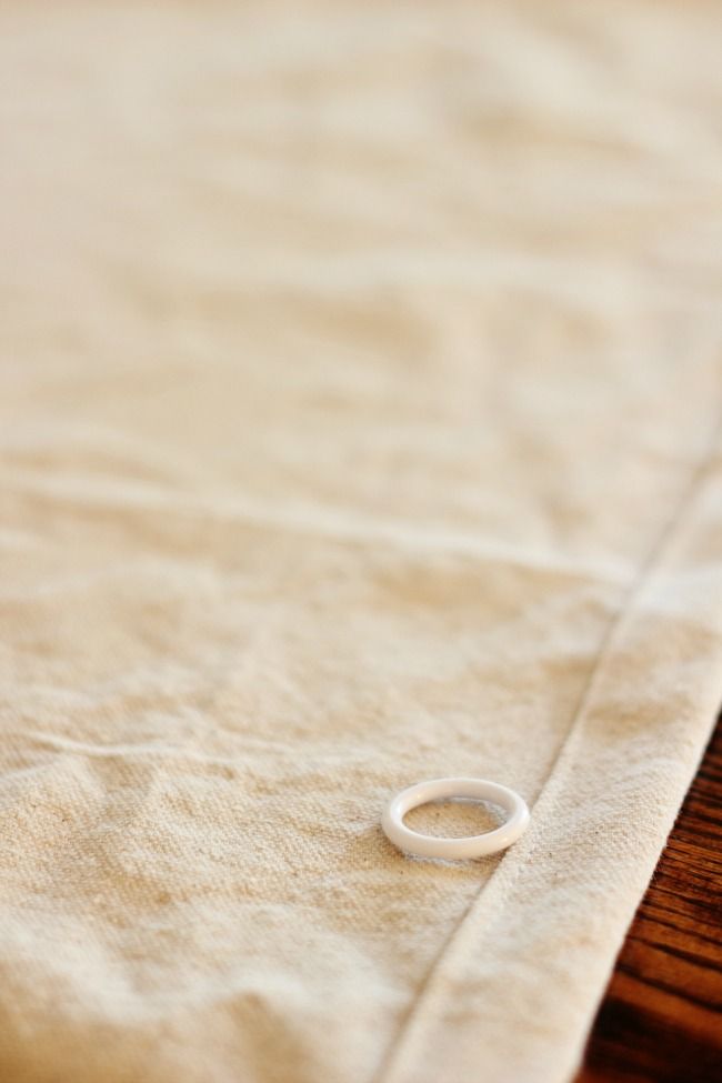 a close up of a piece of cloth with a ring laying on it's side