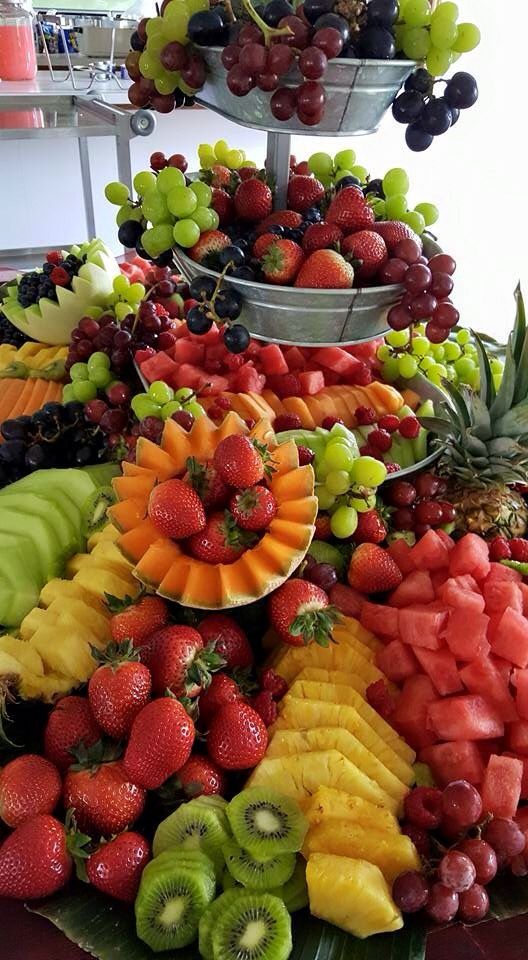 a very large display of fresh fruit on a table